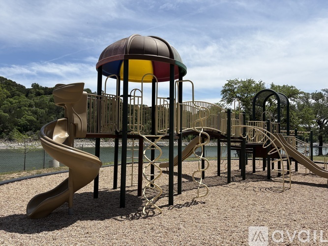 A playground with a yellow slide and a red and blue dome structure.