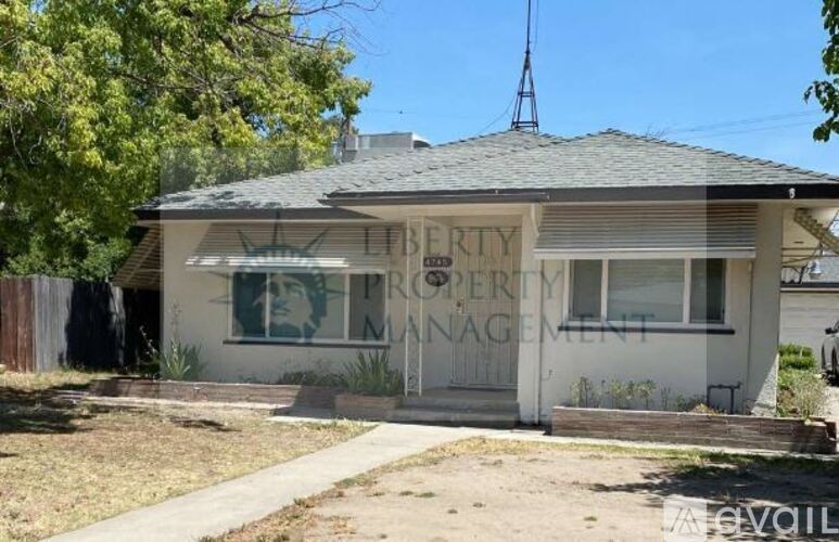 A white building with a sign that says "Property Management".