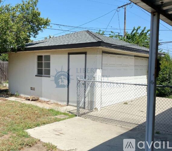 A small white building with a sign that says "LIBERTY" on it.