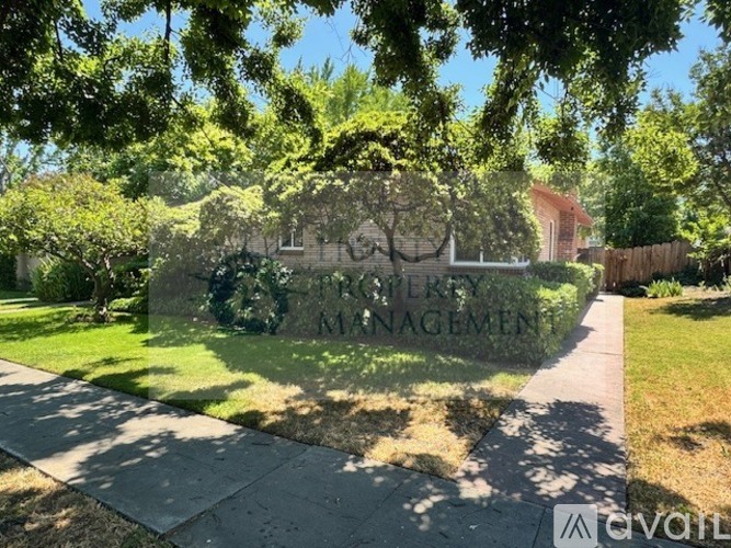 A sign that says "Property Management" is in front of a house.