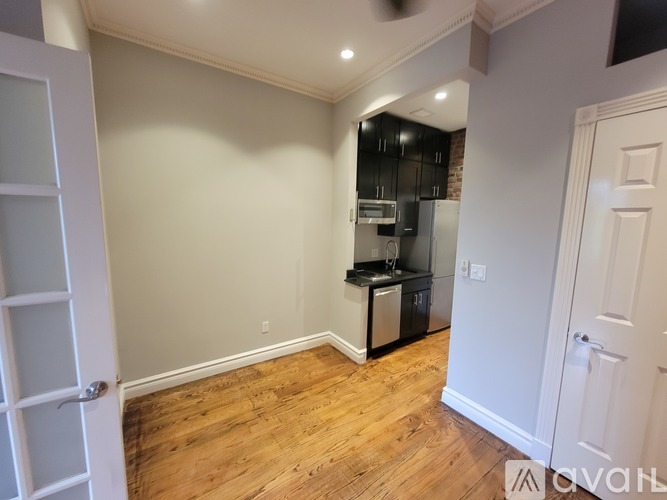 A kitchen area with a refrigerator, microwave, and oven.