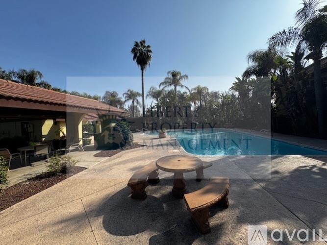 A backyard with a pool and picnic table.