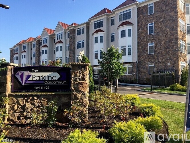 The Parkline Condominium sign in front of a building.