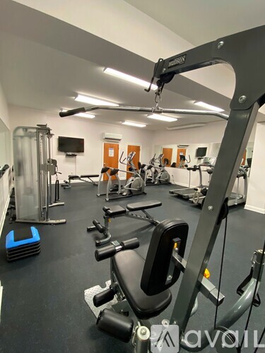 A gym with a variety of equipment including a leg press machine.