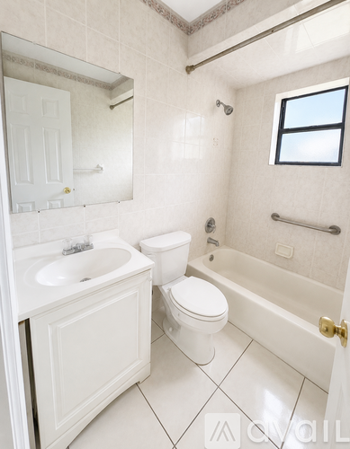 A white bathroom with a toilet, sink, and bathtub.