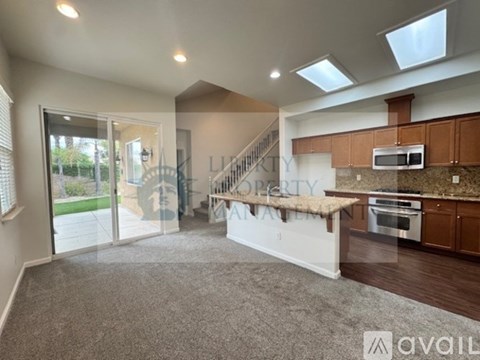 A spacious living room with a staircase leading to the upper floor.