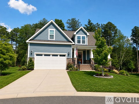 A house with a garage and a flag on the front porch.