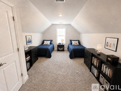 A bedroom with two beds and a dresser.
