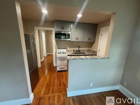A kitchen with a stove top oven and a microwave.