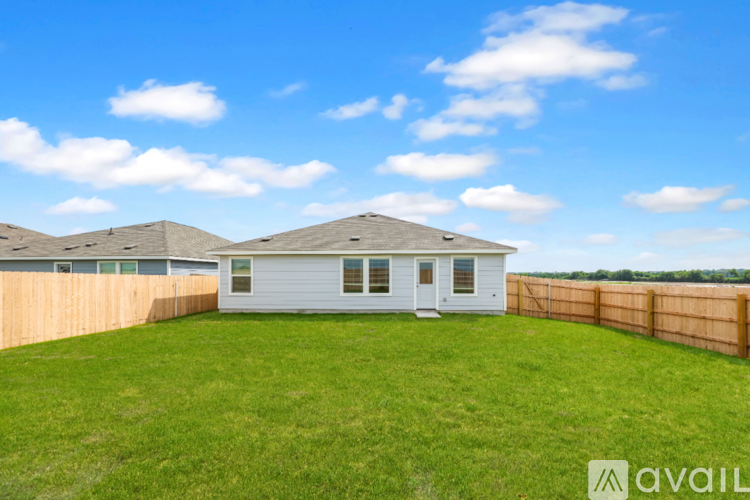 A house with a fence and a grassy yard is for sale.
