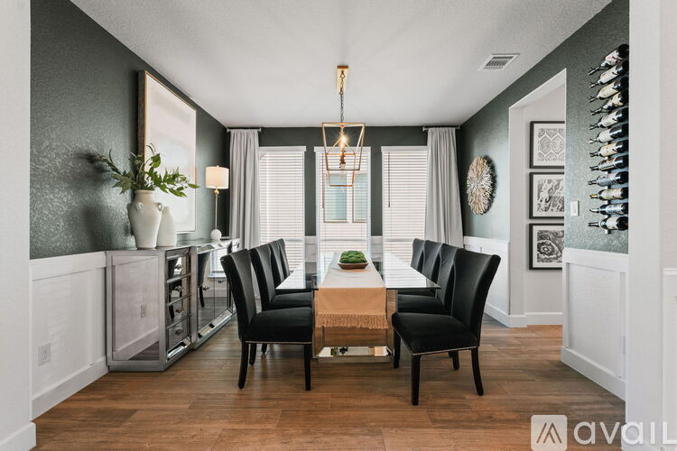 A dining room with a table set for four.