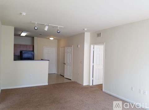 A living room with a television and carpeted floor.