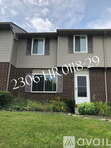 A house numbered 2306 with a white door and windows.