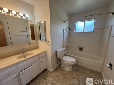 A bathroom with a sink, toilet, and bathtub.