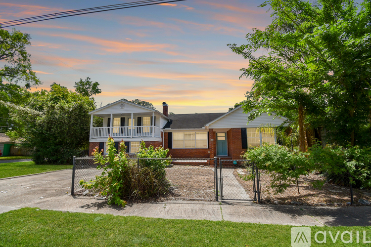 A house with a front yard and a fence.