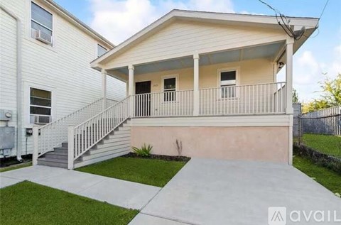 A house with a white exterior and a concrete porch.