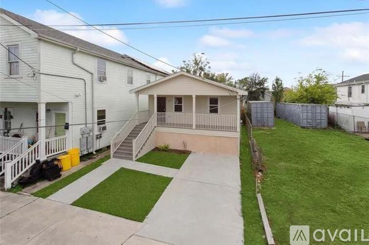 A house with a small front yard and a fence.