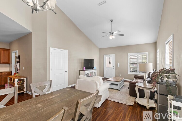A living room with a white couch and a wooden table.