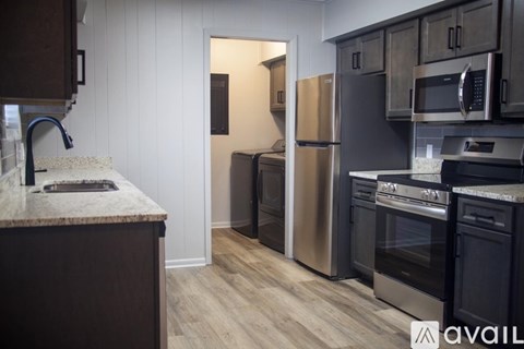 A kitchen with a marble countertop and stainless steel appliances.
