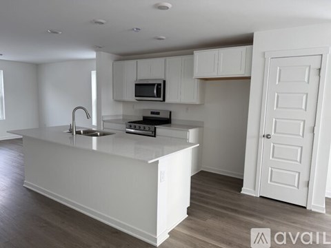 A modern kitchen with white cabinets and a large island.