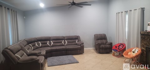 A living room with a large couch and a small table.
