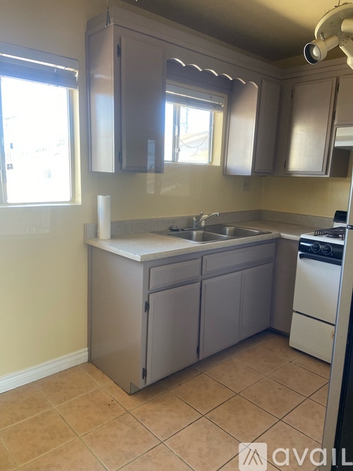 A kitchen with a sink, dishwasher and oven.