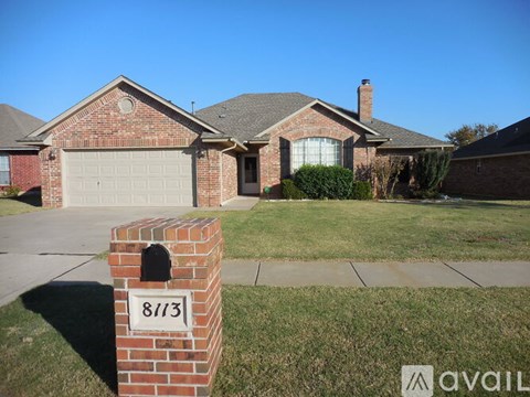 A house with the number 8113 on a brick post in front.