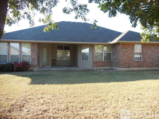 A house with a brick facade and a grey roof.