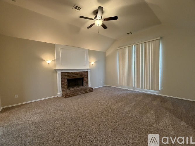A room with a fireplace and a ceiling fan.