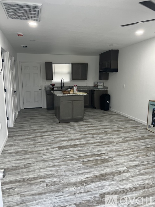 A kitchen with a white door and a counter.