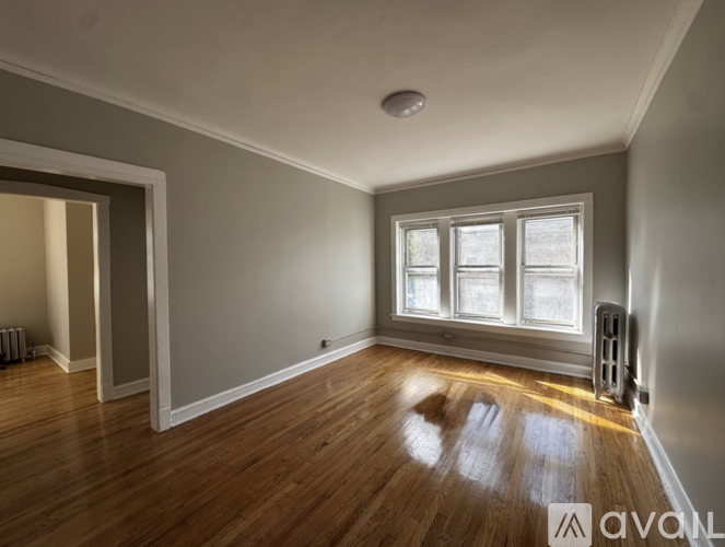 A room with wooden floors and a window.