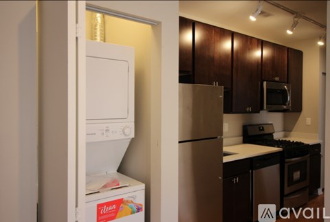 A kitchen with a white dishwasher and a silver refrigerator.