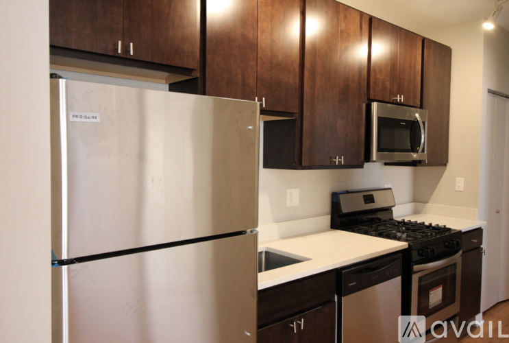 A kitchen with a white refrigerator and black stove top oven.