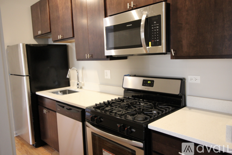 A kitchen with a black fridge, black microwave, black stove and black oven.