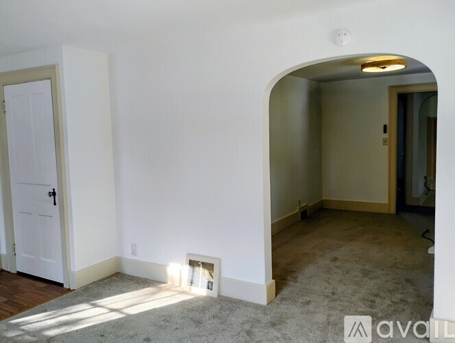A room with a white door and a window with a white frame.