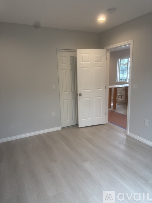 A room with a white door and a window.