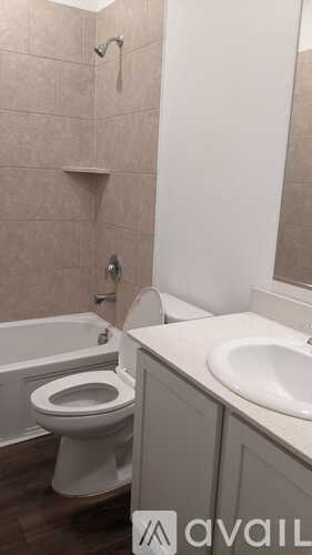 A bathroom with a toilet, sink, and bathtub.