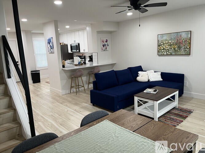 A living room with a blue couch and a coffee table.