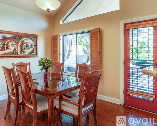 A dining room with a table and chairs.