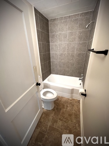 A bathroom with a toilet and a walk-in shower.