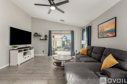 A living room with a grey sofa and a television.
