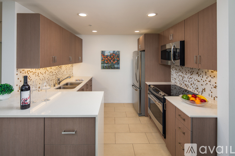A kitchen with brown cabinets and a white countertop.