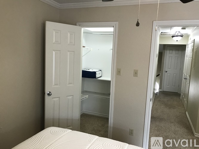 A bedroom with a bed, dresser, and mirror.