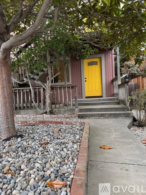 A yellow door is on a red building.