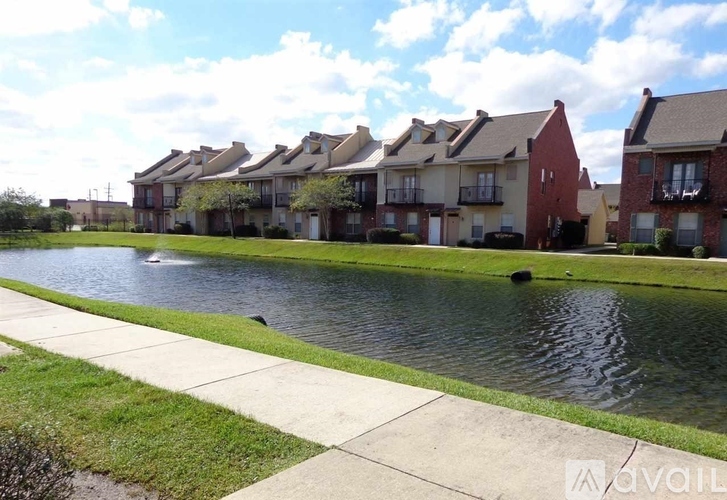 A row of houses with a body of water in front.