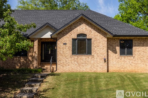 A house with a brick facade and a black door.