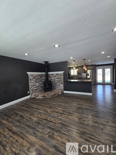 A room with a wood burning stove in the corner.