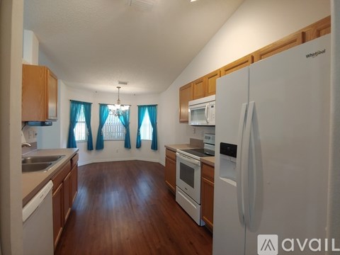 A kitchen with wooden cabinets and a white refrigerator.