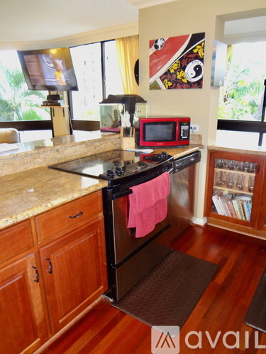 A kitchen with wooden cabinets and a granite counter top.