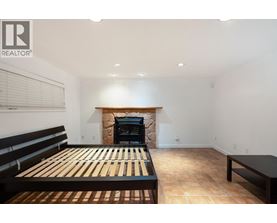 A bedroom with a fireplace and a bed.